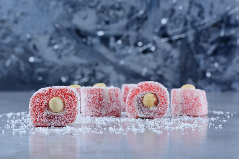 Traditional Turkish delights with coconut powder on a stone background